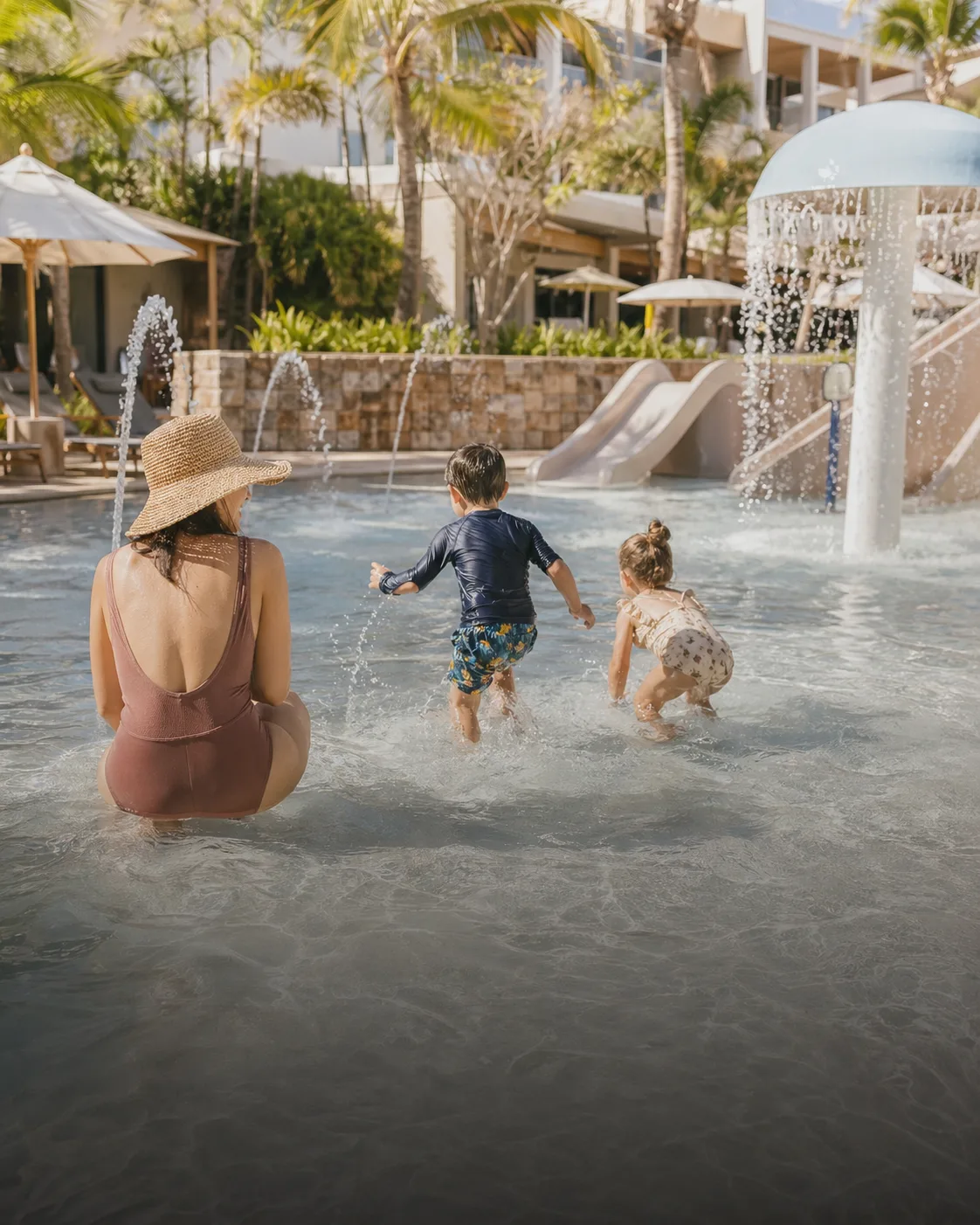 Children playing in a shallow hotel splash pool