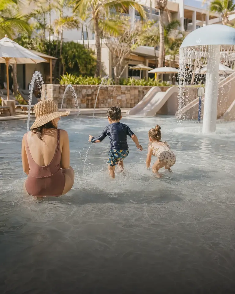 Children playing in a shallow hotel splash pool